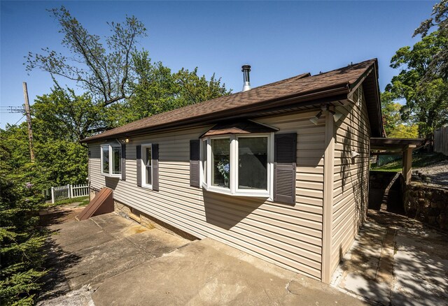 view of property exterior featuring fence and a patio area