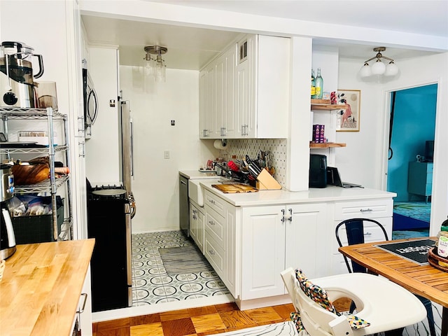 108 Sagamore Rd Unit 5F, Tuckahoe, NY 10707 - kitchen with white cabinetry, butcher block countertops, tasteful backsplash, and stainless steel appliances