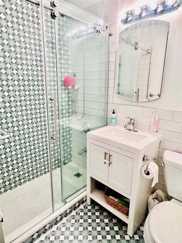 108 Sagamore Rd Unit 5F, Tuckahoe, NY 10707 - full bathroom featuring toilet, a stall shower, tile walls, and vanity