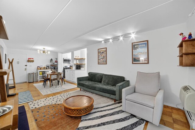 108 Sagamore Rd Unit 5F, Tuckahoe, NY 10707 - living area featuring a chandelier and baseboards