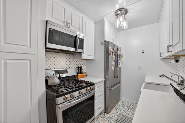108 Sagamore Rd Unit 5F, Tuckahoe, NY 10707 - kitchen featuring stainless steel appliances, white cabinets, tasteful backsplash, and light countertops