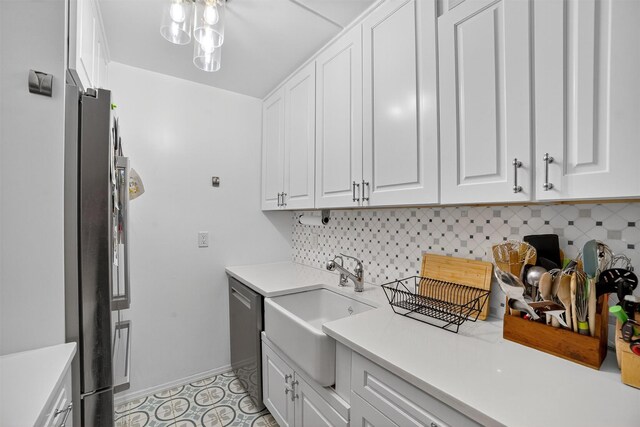 108 Sagamore Rd Unit 5F, Tuckahoe, NY 10707 - kitchen featuring stainless steel appliances, white cabinets, light countertops, and backsplash