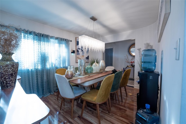dining area featuring a chandelier and wood finished floors