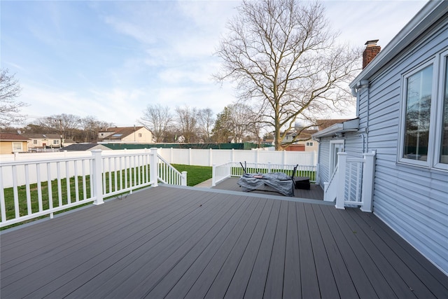 deck with a fenced backyard and a yard