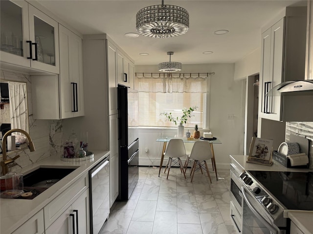 7 Bark Ave, Central Islip, NY 11722 - kitchen featuring a sink, stainless steel appliances, light countertops, glass insert cabinets, and light marble finish floors