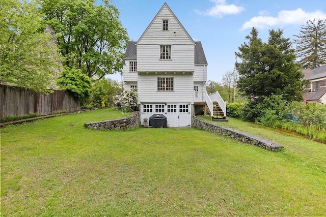 rear view of property featuring stairs, a deck, and a shingled roof