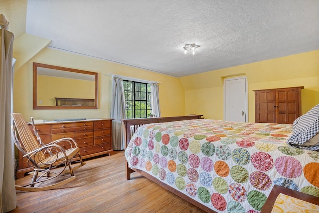 bedroom featuring light wood-style floors and a textured ceiling