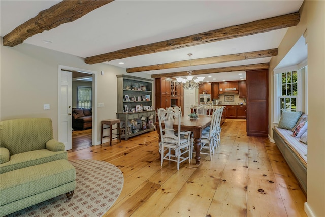 dining space featuring light wood-style floors, beamed ceiling, recessed lighting, and a notable chandelier