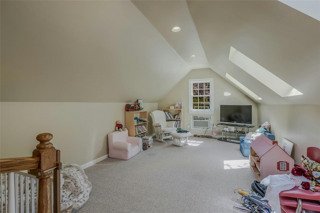 game room featuring vaulted ceiling with skylight, a wall unit AC, baseboards, carpet flooring, and recessed lighting