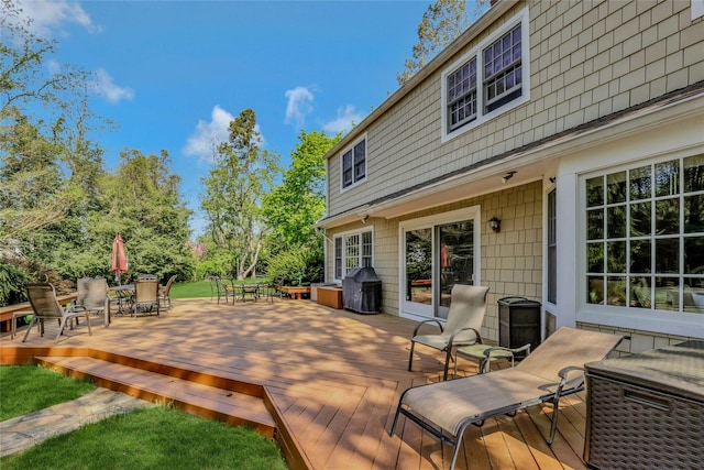 deck featuring outdoor dining space and area for grilling