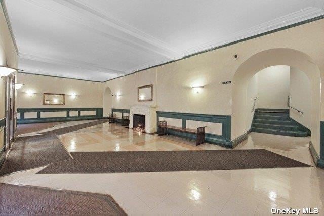 34-24 82nd St Unit 6E, Jackson Heights, NY 11372 - lobby with ornamental molding, a decorative wall, and wainscoting