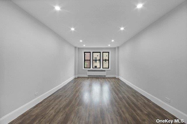 34-24 82nd St Unit 6E, Jackson Heights, NY 11372 - spare room with recessed lighting, baseboards, and dark wood finished floors
