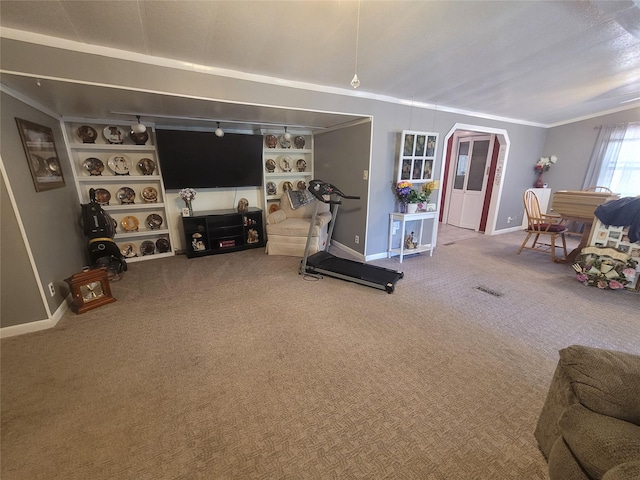 living area with baseboards, carpet, and crown molding