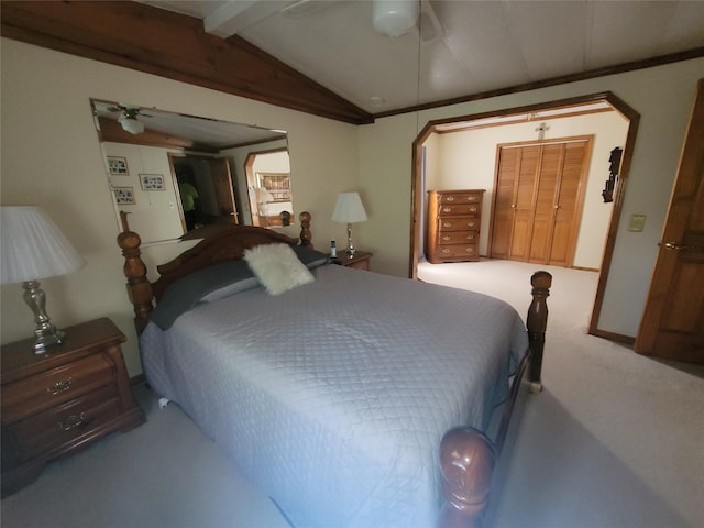 carpeted bedroom featuring lofted ceiling with beams