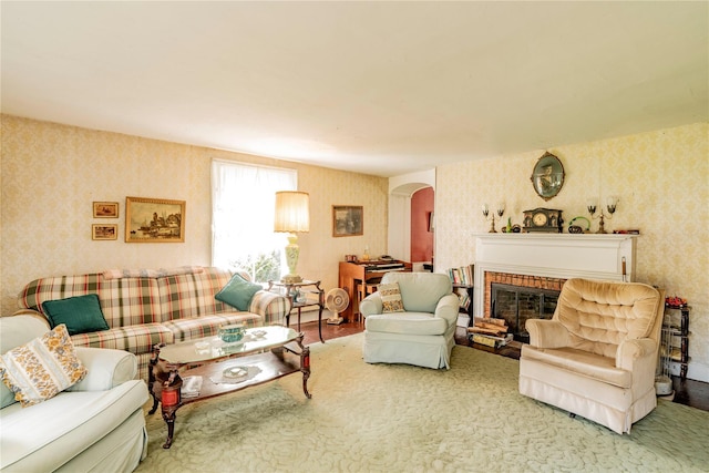 2641 Salt Point Tpke, Clinton Corners, NY 12514 - living room featuring arched walkways, wallpapered walls, and a brick fireplace