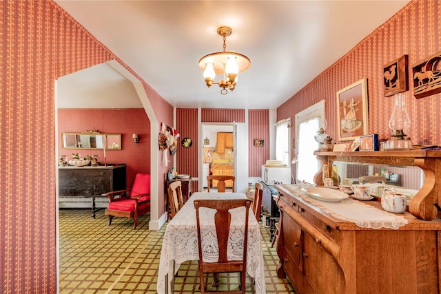 2641 Salt Point Tpke, Clinton Corners, NY 12514 - dining area with wallpapered walls, a chandelier, a baseboard radiator, and arched walkways