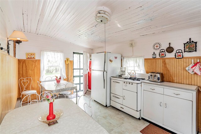 2641 Salt Point Tpke, Clinton Corners, NY 12514 - kitchen featuring freestanding refrigerator, lofted ceiling, white cabinetry, light countertops, and wooden ceiling