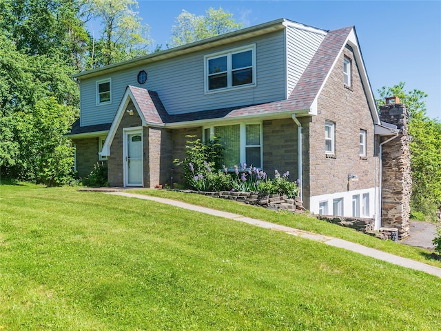 57 E Rock Cut Rd, Walden, NY 12586 - view of front of home featuring a front lawn, stone siding, and a shingled roof