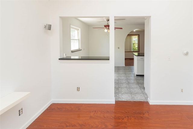 57 E Rock Cut Rd, Walden, NY 12586 - empty room with a ceiling fan, healthy amount of natural light, baseboards, and arched walkways