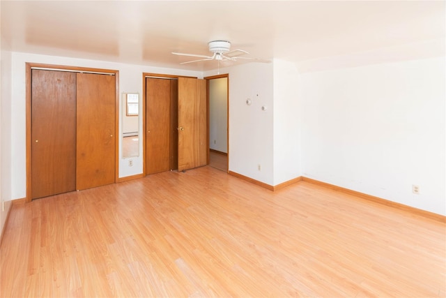 57 E Rock Cut Rd, Walden, NY 12586 - unfurnished bedroom with two closets, light wood-type flooring, baseboards, and a ceiling fan
