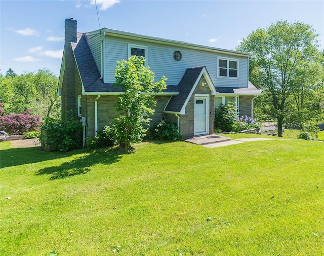57 E Rock Cut Rd, Walden, NY 12586 - view of front of house featuring a chimney, a front yard, and stone siding