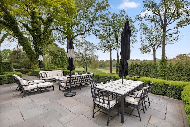 view of patio / terrace with an outdoor living space and outdoor dining area