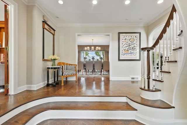entryway featuring baseboards, recessed lighting, a chandelier, crown molding, and stairs