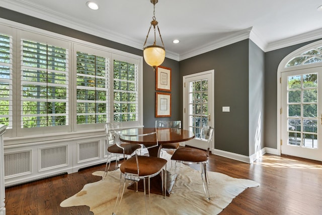 dining room featuring baseboards, wood finished floors, crown molding, and recessed lighting