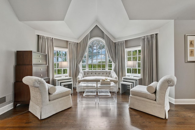 sitting room with baseboards, vaulted ceiling, and wood finished floors