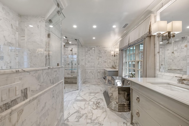 full bathroom with a stall shower, marble finish floors, two vanities, a freestanding tub, and recessed lighting