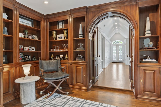 living area featuring arched walkways, hardwood / wood-style flooring, french doors, vaulted ceiling, and recessed lighting