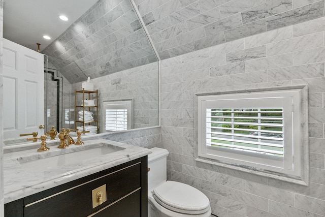 bathroom featuring tile walls, vanity, toilet, recessed lighting, and tiled shower
