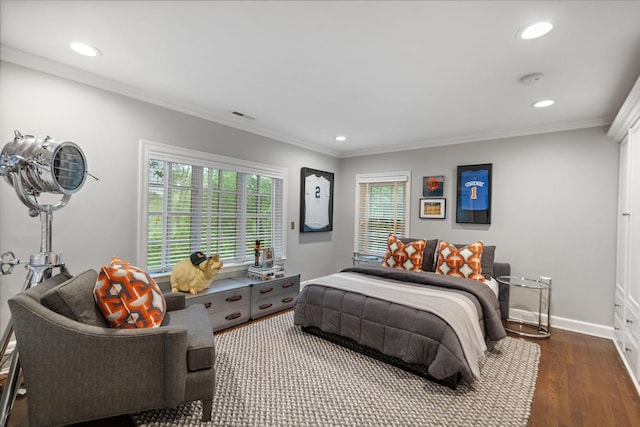 bedroom with wood finished floors, recessed lighting, ornamental molding, and baseboards