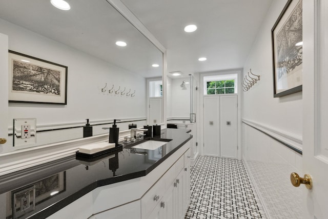 full bathroom with recessed lighting, wainscoting, a stall shower, and vanity