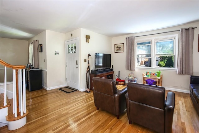 82 Sprague Rd, Scarsdale, NY 10583 - living room with stairway, baseboards, and light wood finished floors