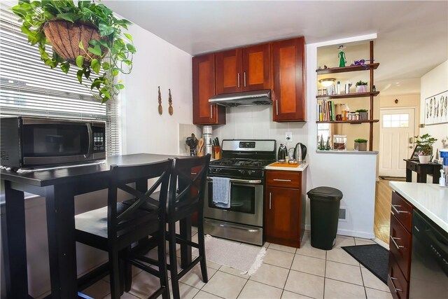 82 Sprague Rd, Scarsdale, NY 10583 - kitchen with open shelves, appliances with stainless steel finishes, light countertops, light tile patterned floors, and under cabinet range hood