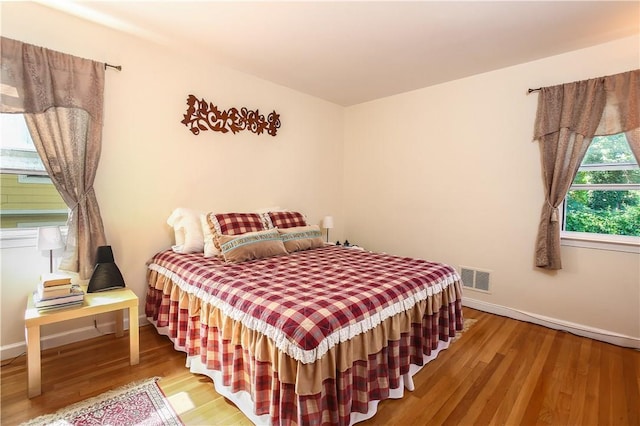 82 Sprague Rd, Scarsdale, NY 10583 - bedroom featuring baseboards, wood finished floors, and visible vents