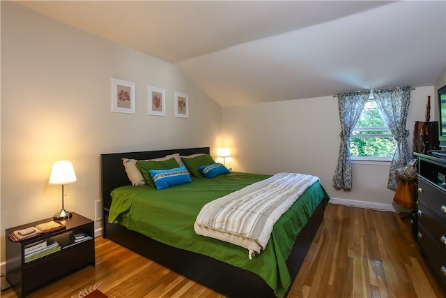 82 Sprague Rd, Scarsdale, NY 10583 - bedroom with baseboards, vaulted ceiling, and wood finished floors