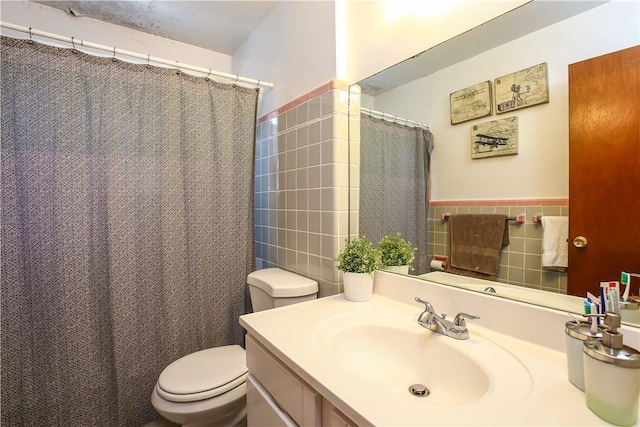 82 Sprague Rd, Scarsdale, NY 10583 - bathroom featuring vanity, wainscoting, toilet, and tile walls
