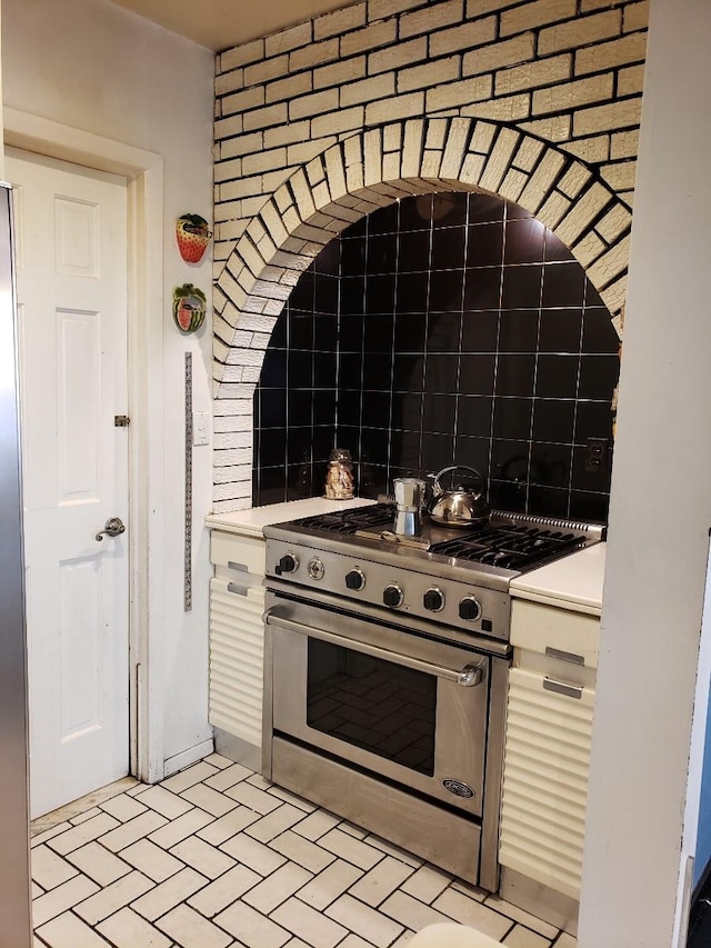 214-40 24th Ave, Bayside, NY 11360 - kitchen with high end stove, white cabinetry, light countertops, and brick patterned floors