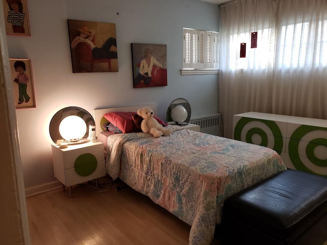 214-40 24th Ave, Bayside, NY 11360 - bedroom with wood finished floors, radiator, and baseboards