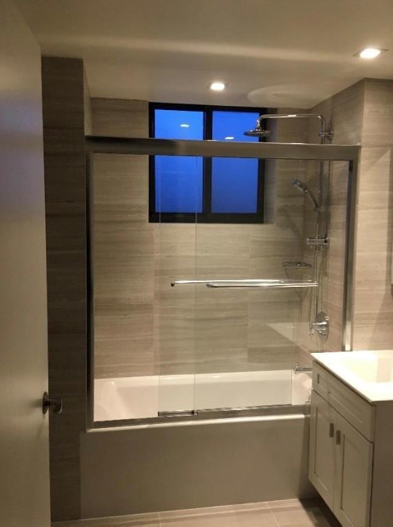 full bathroom featuring recessed lighting, combined bath / shower with glass door, tile patterned flooring, and vanity