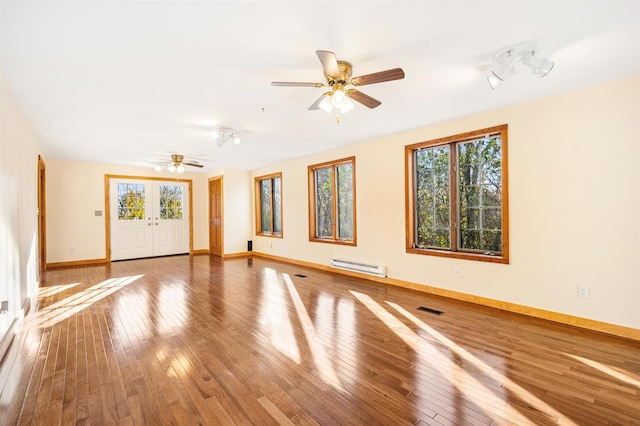 53 Jameson Hill Rd, Clinton Corners, NY 12514 - empty room featuring a baseboard radiator, healthy amount of natural light, ceiling fan, and hardwood / wood-style flooring