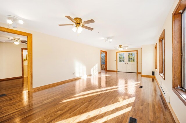53 Jameson Hill Rd, Clinton Corners, NY 12514 - unfurnished living room with ceiling fan, a baseboard radiator, hardwood / wood-style flooring, and baseboards
