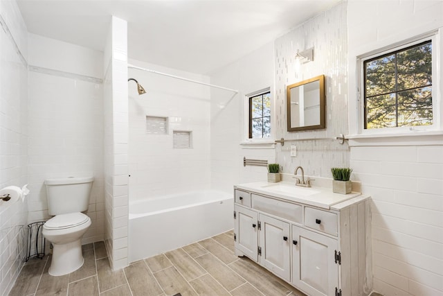 53 Jameson Hill Rd, Clinton Corners, NY 12514 - bathroom with tile walls, vanity, toilet, wood tiled floors, and shower / bath combination