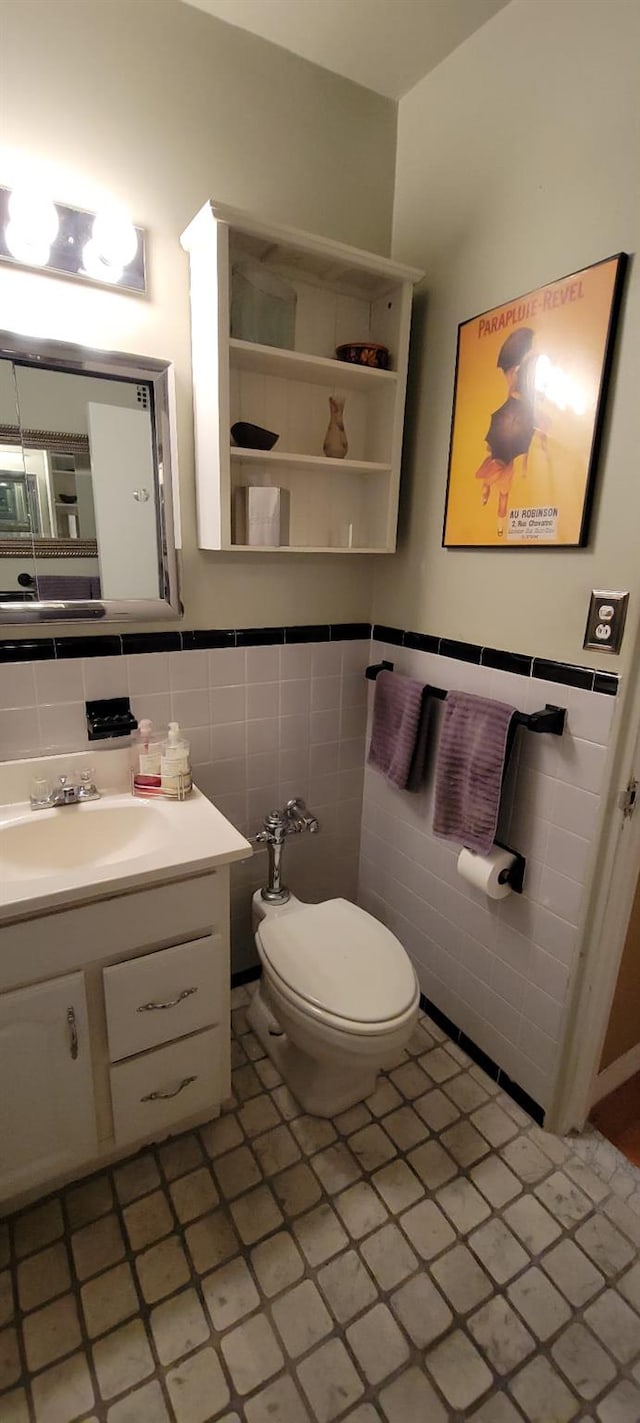 2601 Henry Hudson Pkwy Unit 5E, Bronx, NY 10463 - bathroom featuring tile walls, vanity, toilet, tile patterned flooring, and a wainscoted wall