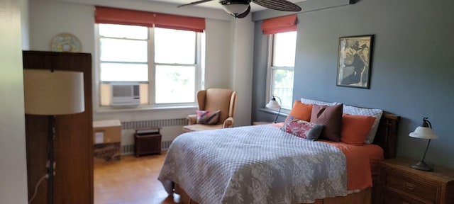 2601 Henry Hudson Pkwy Unit 5E, Bronx, NY 10463 - bedroom with radiator, light wood-style floors, cooling unit, and ceiling fan