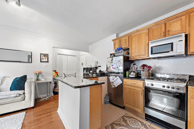4523 Broadway Ave Unit 7D, New York Manhattan, NY 10040 - kitchen with crown molding, a kitchen island, stainless steel appliances, and dark stone countertops