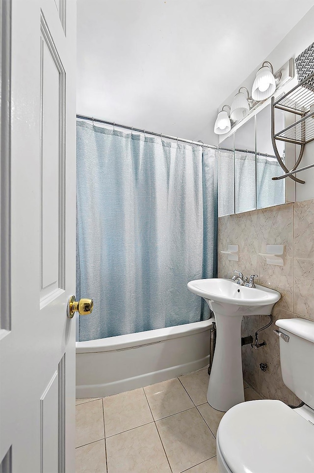 4523 Broadway Ave Unit 7D, New York Manhattan, NY 10040 - bathroom featuring tile patterned floors, toilet, tile walls, and shower / bath combination with curtain