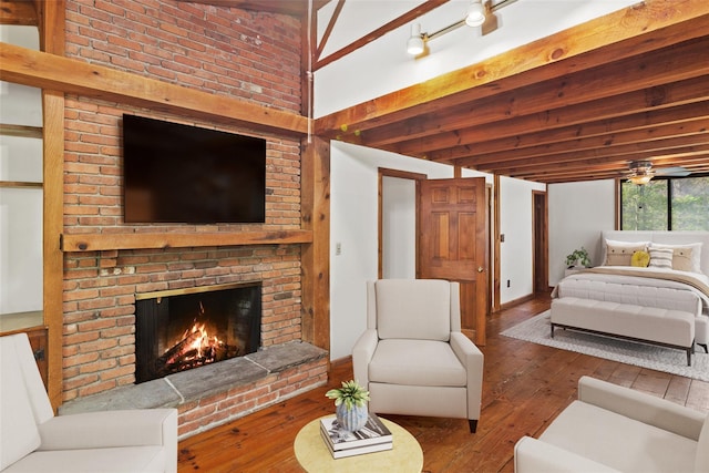 living room with wood-type flooring and a brick fireplace